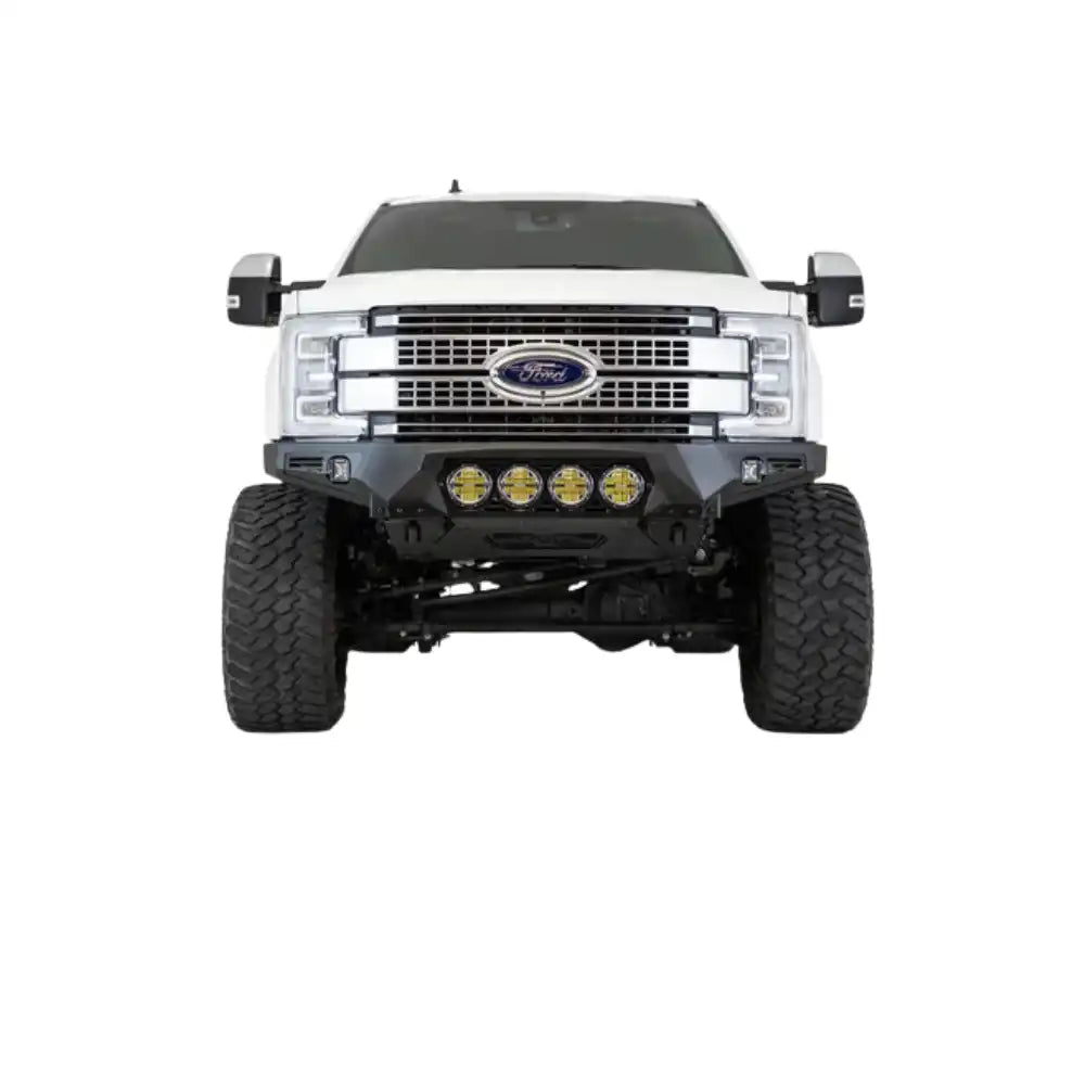 White Ford F-Series pickup truck with a lifted suspension and off-road bumper